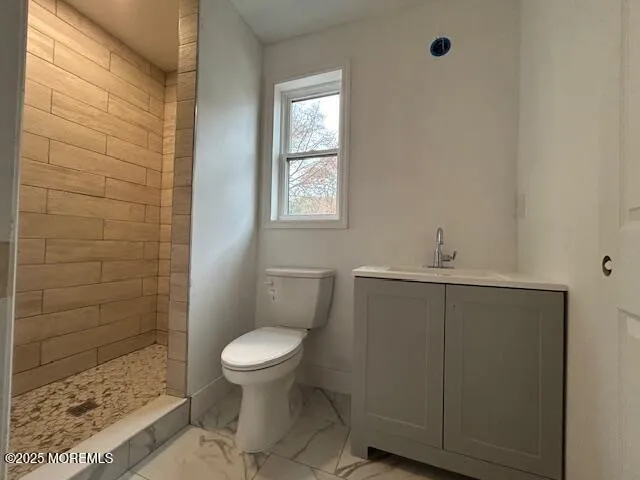a bathroom with a toilet a sink a shower and a window