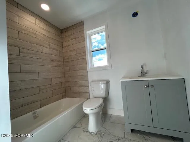 a bathroom with a toilet a sink and bathtub