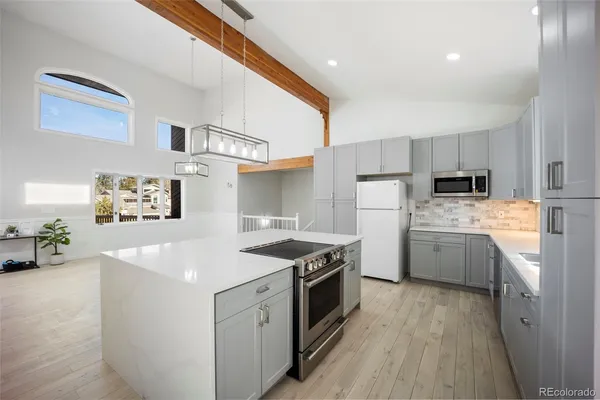 a kitchen with a stove a sink and a refrigerator
