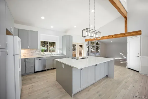 a kitchen with white cabinets and white appliances