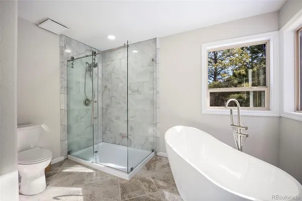 a bathroom with a toilet sink and shower