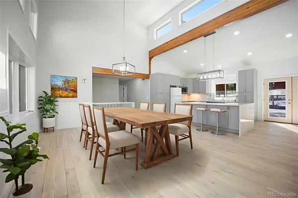 a dining room with furniture and wooden floor
