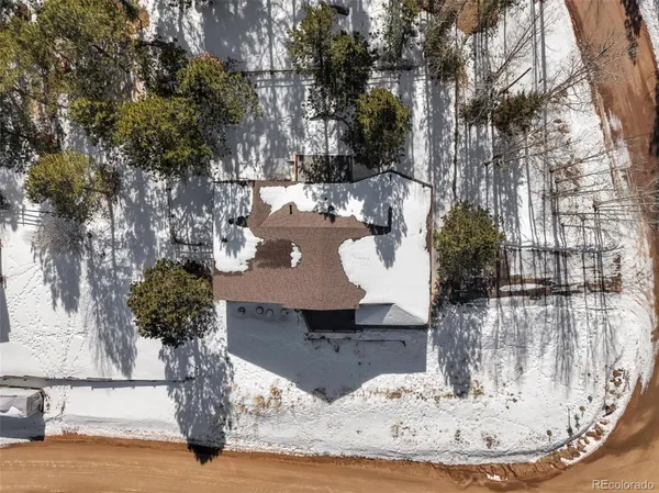 a view of a building with snow on the road