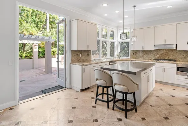 wooden floor in an empty room with kitchen view