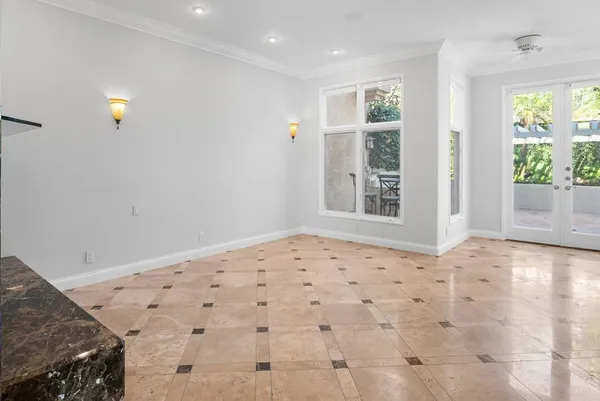 a view of a hallway with wooden floor and a kitchen