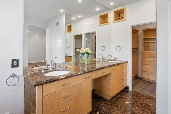 a bathroom with a granite countertop sink and a mirror