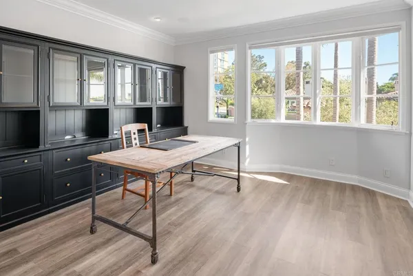a view of a livingroom with wooden floor and a bathroom space
