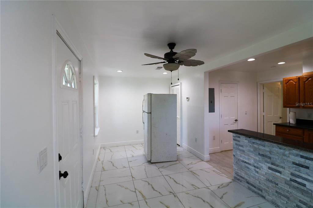 1518 Indiana Street Orlando, FL 32805 - Photo 12 of 17 a view of a hallway with a kitchen