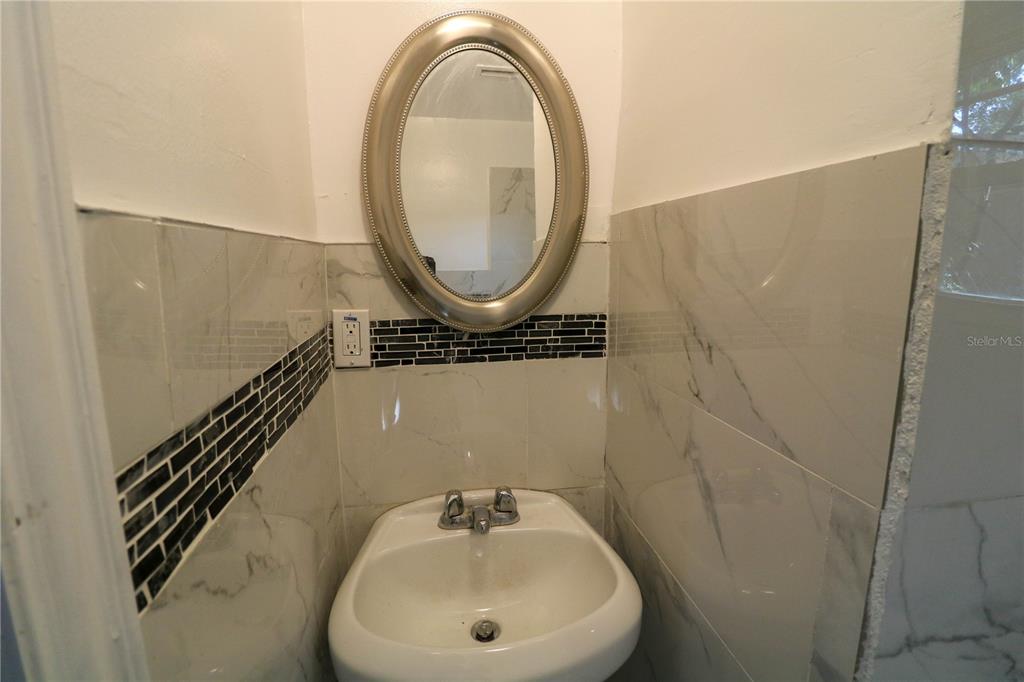 1518 Indiana Street Orlando, FL 32805 - Photo 14 of 17 a bathroom with a sink and a mirror