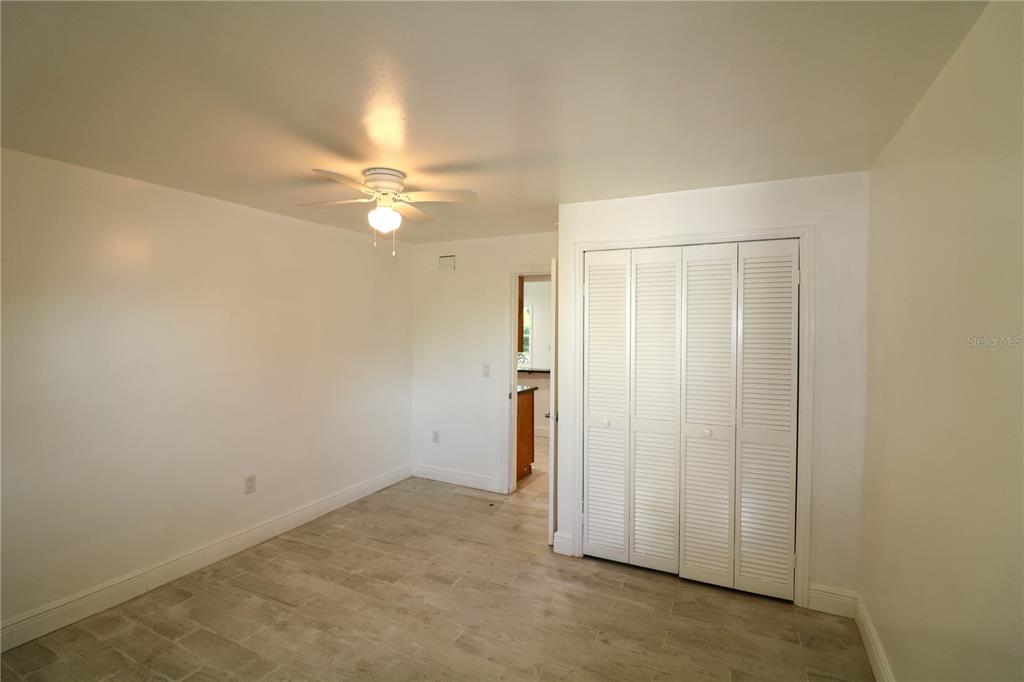 1518 Indiana Street Orlando, FL 32805 - Photo 16 of 17 an empty room with a ceiling fan and a window