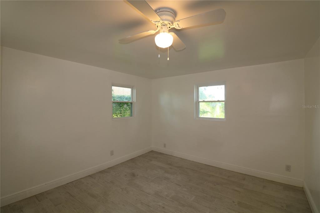 1518 Indiana Street Orlando, FL 32805 - Photo 17 of 17 an empty room with a window and a fan