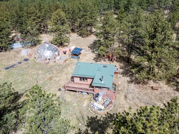 an aerial view of a house with a yard