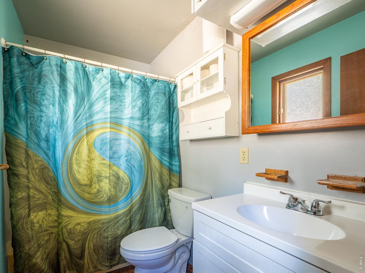 263 Badger Court Drake, CO 80515 - Photo 19 of 41 a bathroom with a sink a mirror a toilet and a window