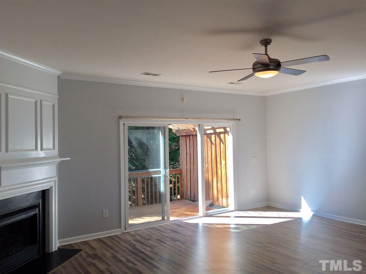 8511 Mt Valley Lane Raleigh, NC 27613 - Photo 12 of 25 a view of an empty room with wooden floor and a window