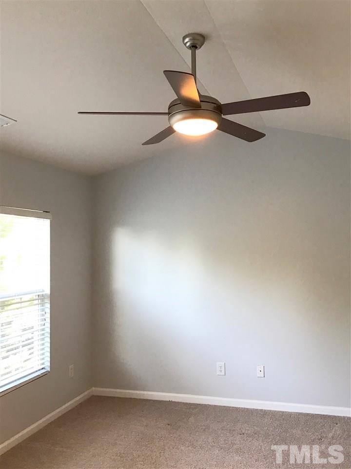 8511 Mt Valley Lane Raleigh, NC 27613 - Photo 14 of 25 an empty room with a window and a ceiling fan