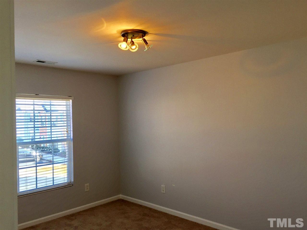 8511 Mt Valley Lane Raleigh, NC 27613 - Photo 18 of 25 an empty room with a window