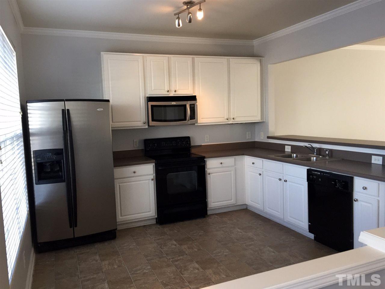 8511 Mt Valley Lane Raleigh, NC 27613 - Photo 5 of 25 a kitchen with a refrigerator sink and microwave