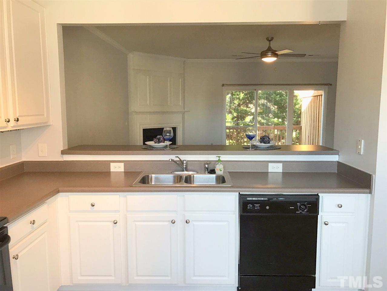 8511 Mt Valley Lane Raleigh, NC 27613 - Photo 7 of 25 a kitchen with a sink cabinets and window