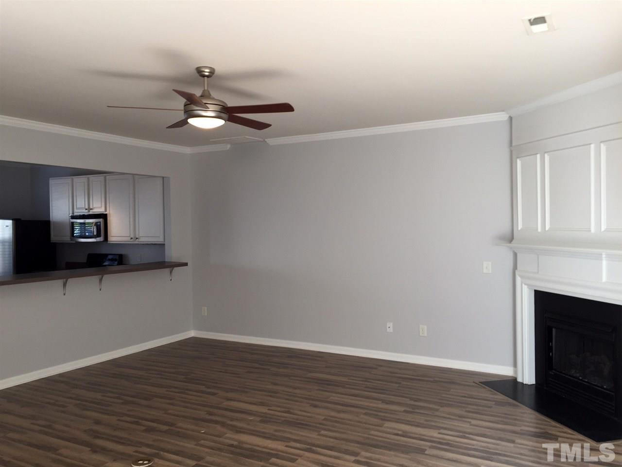 8511 Mt Valley Lane Raleigh, NC 27613 - Photo 9 of 25 a view of an empty room with a fireplace and a window