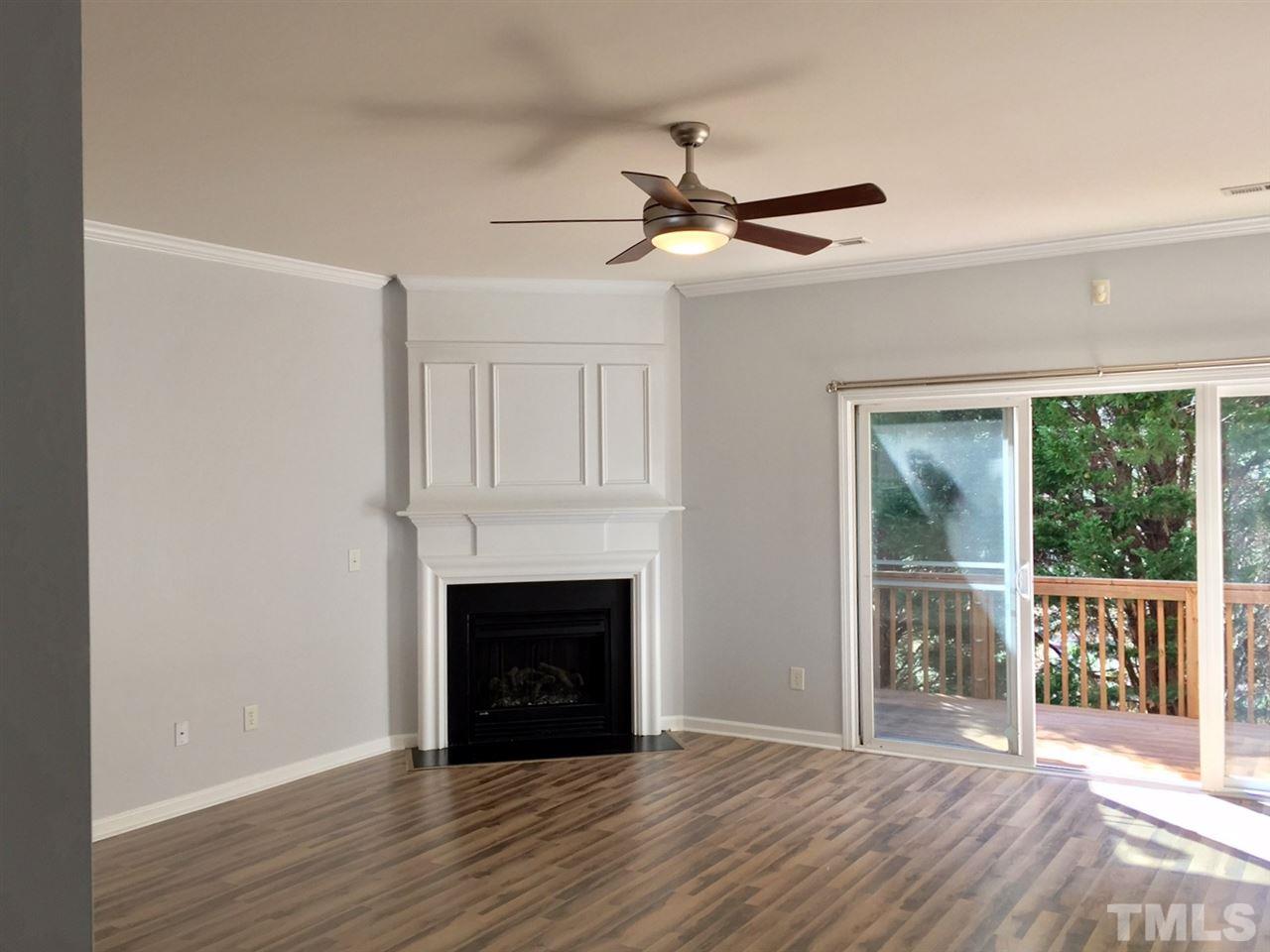 8511 Mt Valley Lane Raleigh, NC 27613 - Photo 10 of 25 a view of empty room with wooden floor and fan