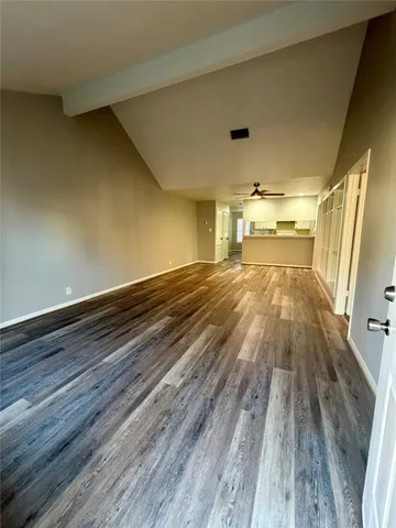a view of a room with wooden floor