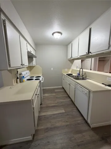 a kitchen that has a sink and a stove