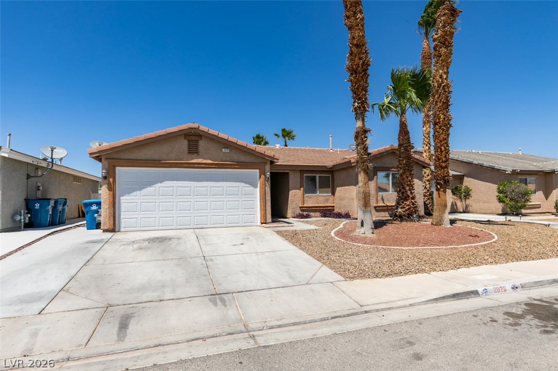 2028 Rustler Ridge Avenue North Las Vegas, NV 89031 - Photo 3 of 40 A desert-friendly landscape surrounds this charming single-story residence with an attached garage.