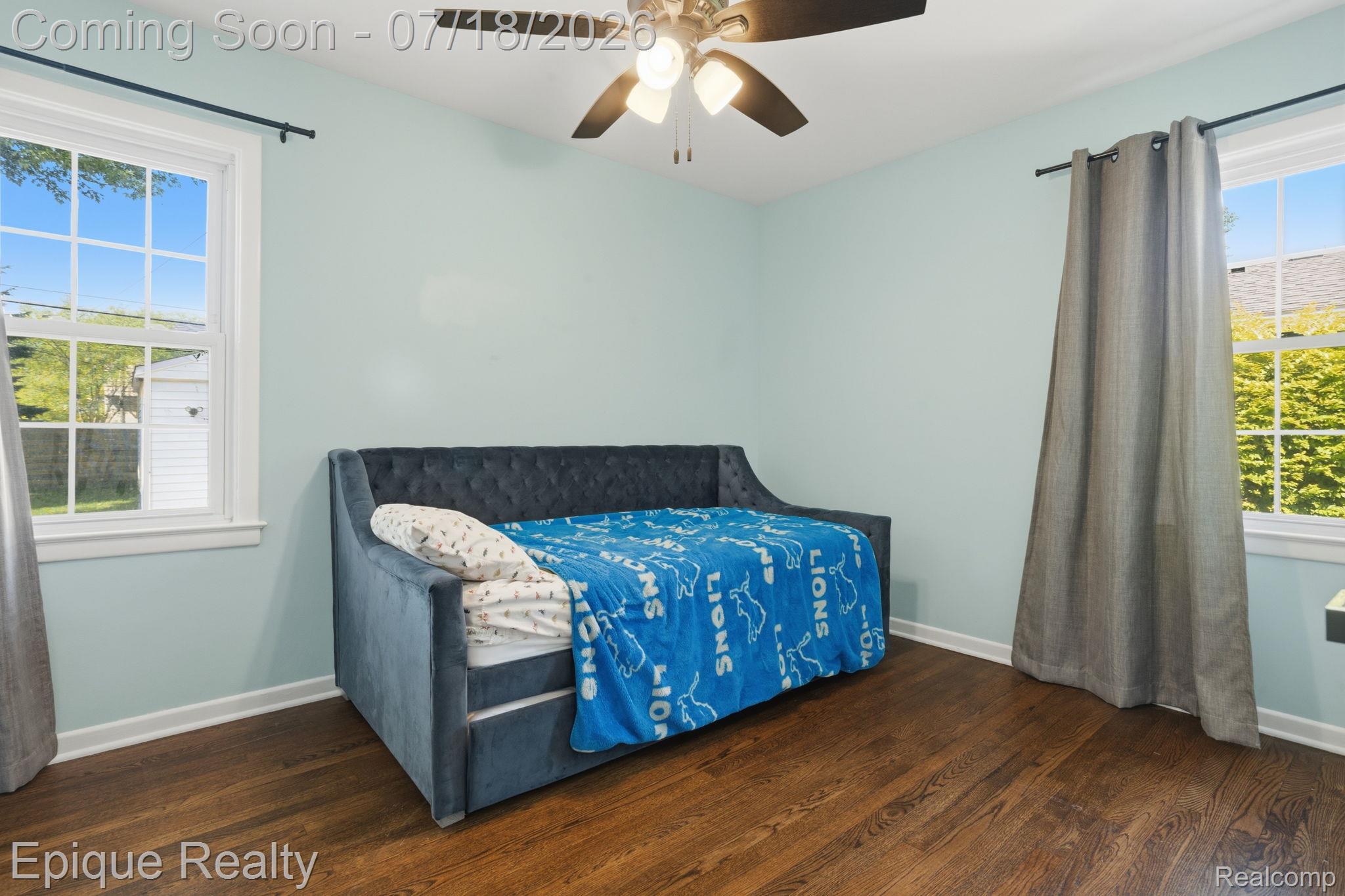 1206 Hawthorne Road Grosse Pointe, MI 48236 - Photo 12 of 28 Spacious room featuring rich wood-finish flooring, light blue walls, and white trim