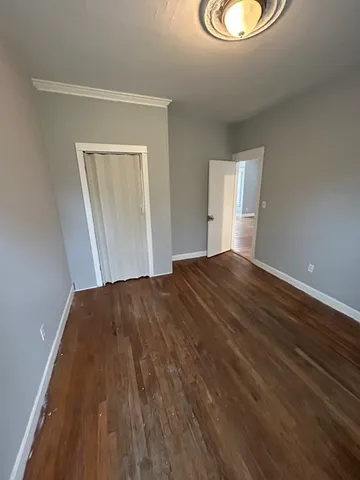 a view of a room with wooden floor and window