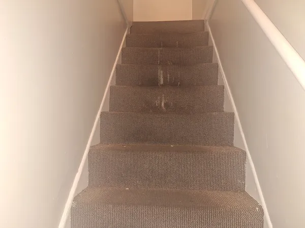 a view of staircase with white walls