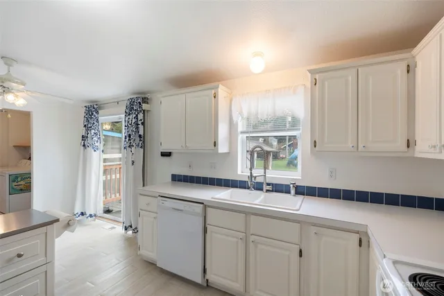 a kitchen with a sink cabinets and window
