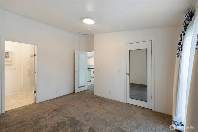 an empty room with closet area