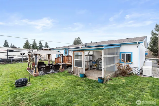 a view of a house with a backyard porch and sitting area