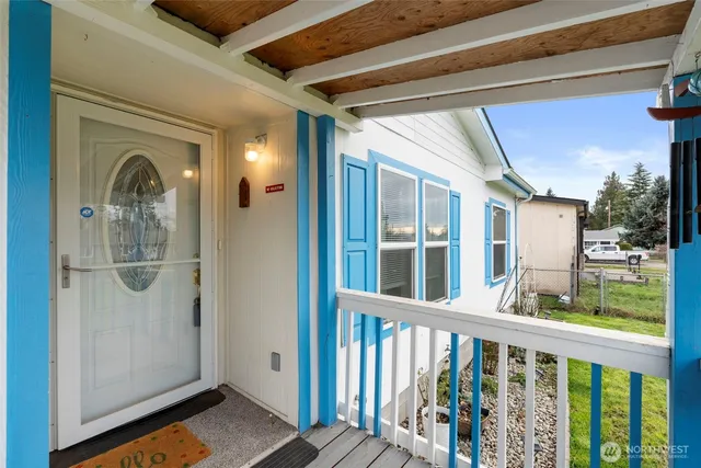 a view of a porch with a table and chairs