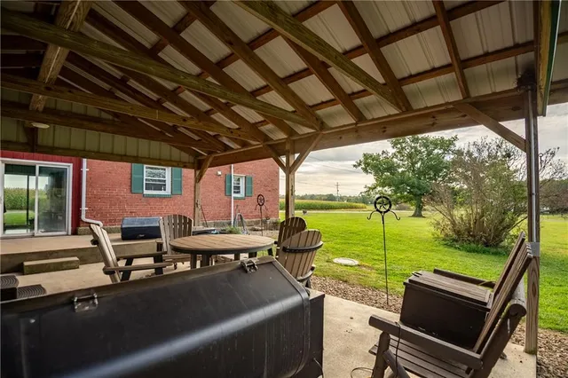 a view of a patio with chairs and a table