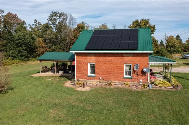 an outdoor view of the house with outdoor seating