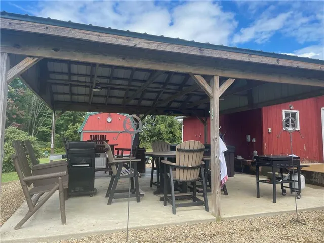 a patio with glass top table and chairs