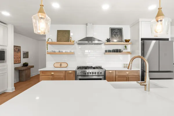 a kitchen with stainless steel appliances granite countertop a stove and cabinets