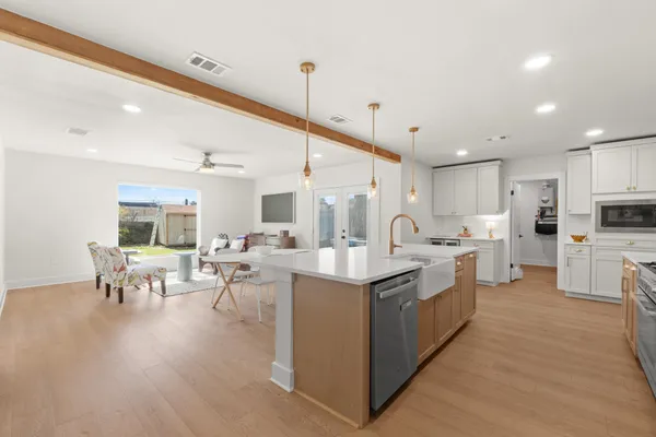 a large kitchen with lots of counter top space and chairs