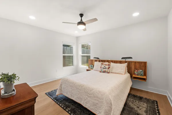 a bedroom with a bed and a potted plant