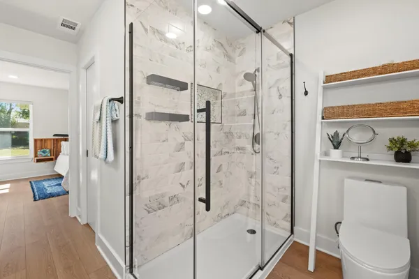 a bathroom with a shower and a toilet