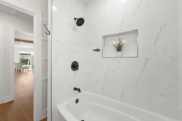 a bathroom with a bathtub and a shower