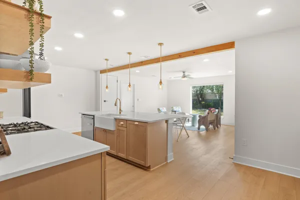a kitchen with a table chairs and a window