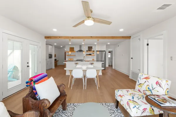 a living room with furniture and wooden floor