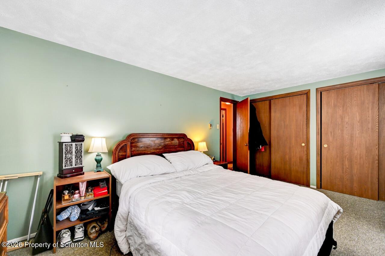 1317 Heart Lake Road Scott Township, PA 18433 - Photo 29 of 60 a bedroom with a large bed and a book shelf