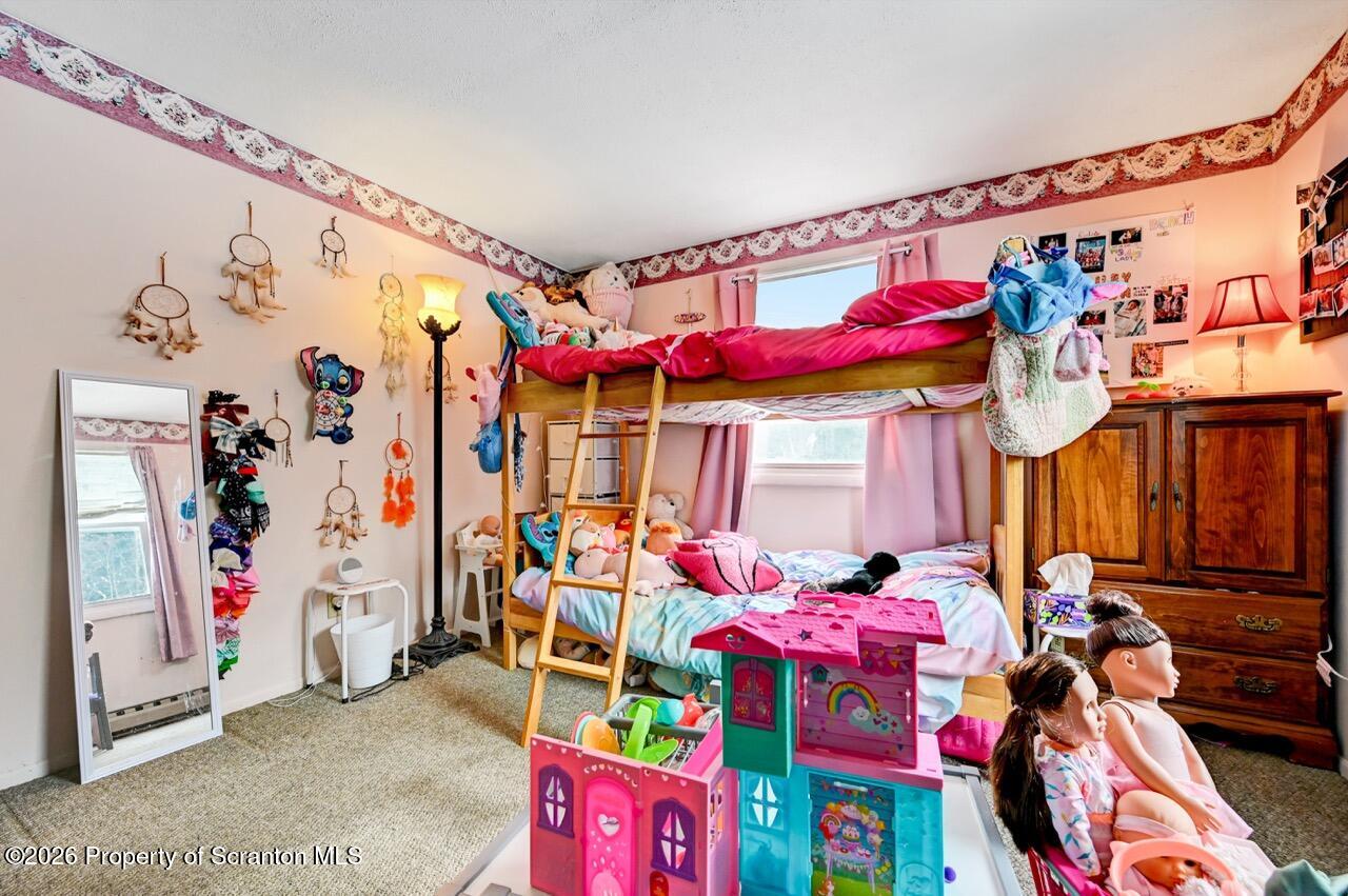 1317 Heart Lake Road Scott Township, PA 18433 - Photo 36 of 60 a bedroom with a bed a couch and a window