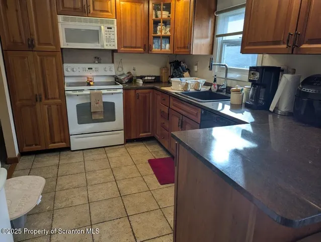 a kitchen with stainless steel appliances a sink stove and cabinets