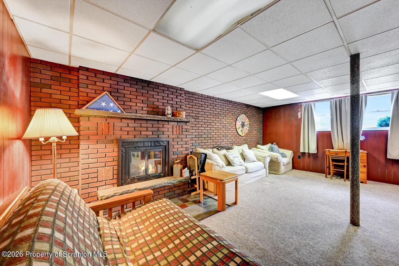 1317 Heart Lake Road Scott Township, PA 18433 - Photo 44 of 60 a living room with furniture a rug and a fireplace