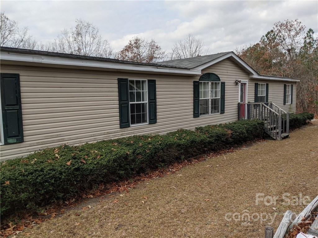 1449 State Rd S-28-313 Cassatt, SC 29032 - Photo 1 of 13 a front view of a house with garden
