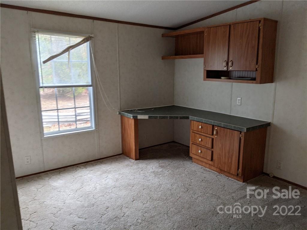 1449 State Rd S-28-313 Cassatt, SC 29032 - Photo 5 of 13 a kitchen with stainless steel appliances granite countertop a stove a sink and a microwave
